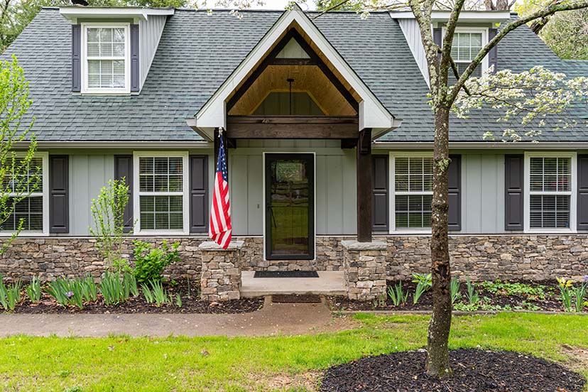 Beautiful front porch features a vaulted entry and stunning rock work
