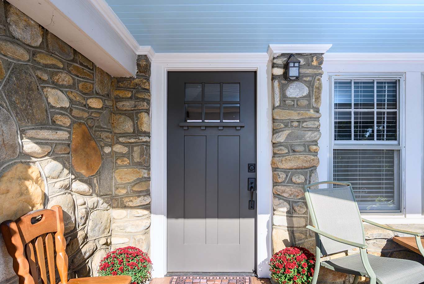 Craftsman style front door complements this stone bungalow