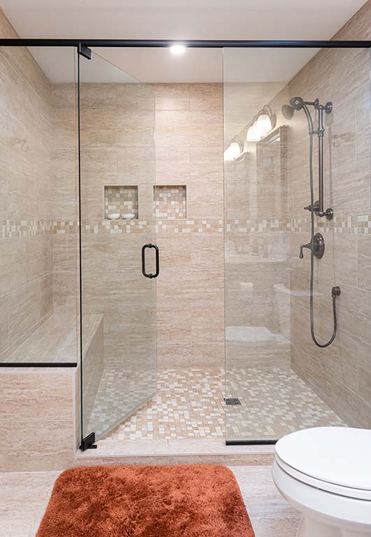 Clean Slate Renovation included a huge glass enclosed shower with intricate tile work,