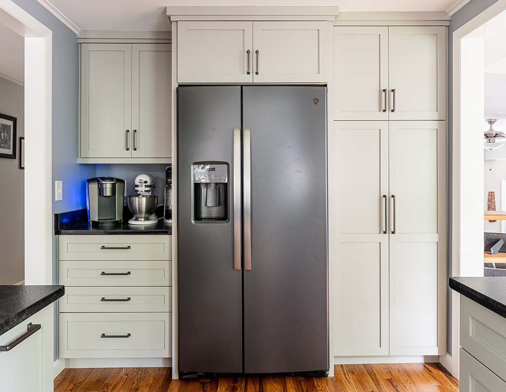 Semper Fi Custom Remodeling Kitchens - black stainless steel appliances compliment the white cabinets