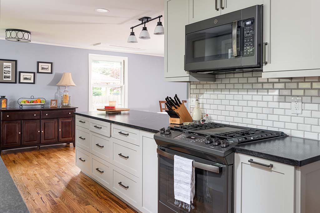 Semper Fi Custom Remodeling Kitchens - Classic white cabinets and a white subway tile backsplash make this home modern.