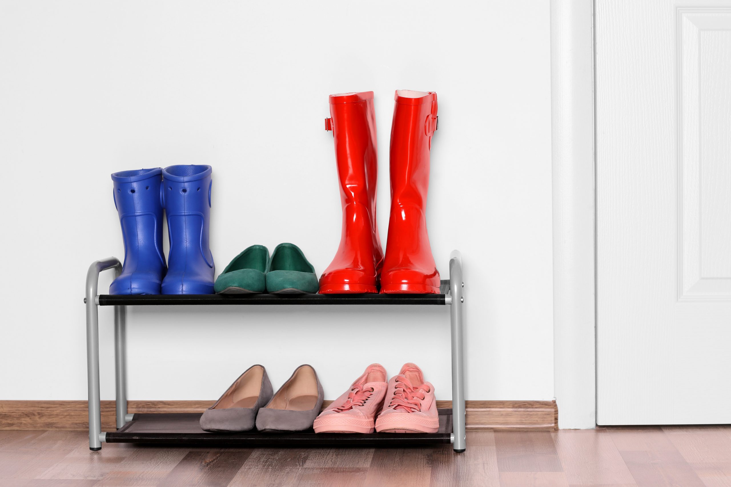 Different shoes on shelf near wall