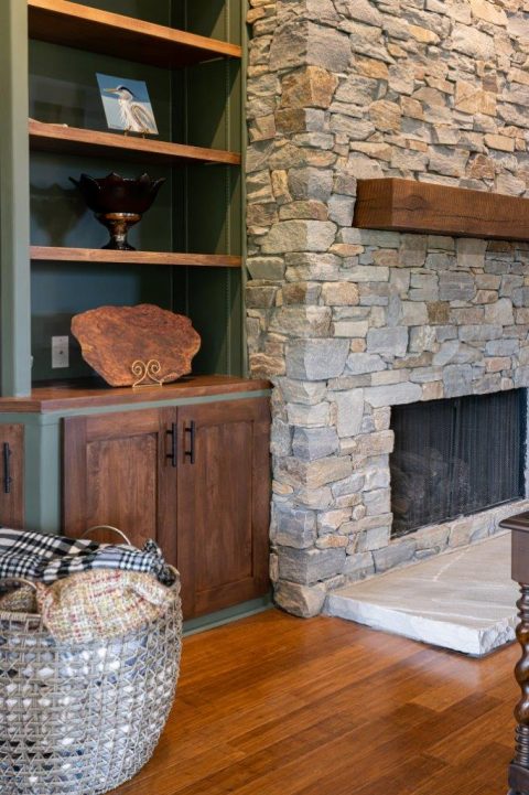 Wood mantle on stone fireplace in Black Mountain, North Carolina.