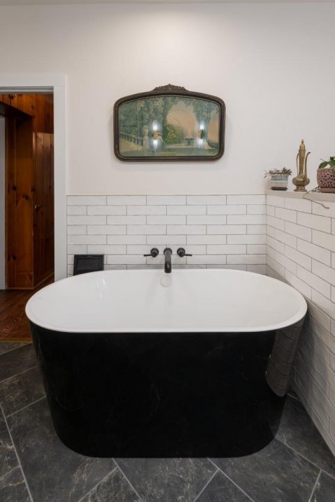 Freestanding tub with white subway tiles wall in Black Mountain, NC.