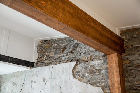 Close up detail of overhead beam with exposed rock wall. Black Mountain, North Carolina.