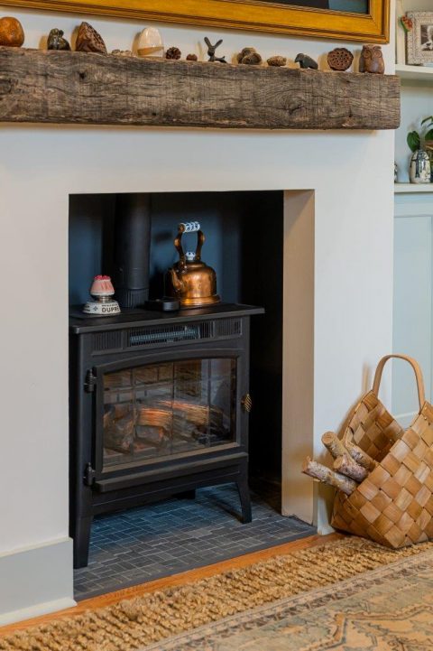 Cozy fireplace with wooden mantle in Black Mountain, North Carolina.