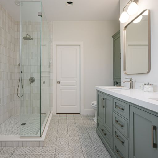 View of glass shower and double vanity