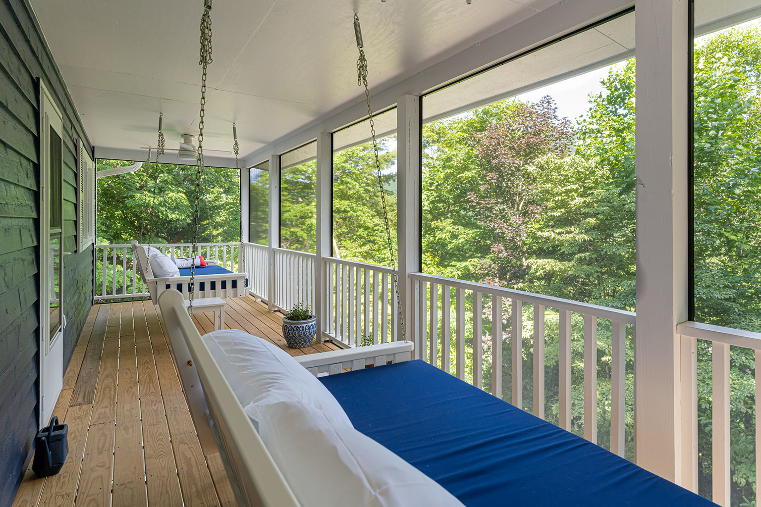 Renovated screened porch and deck with swing